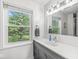Bright bathroom features a white marble countertop, undermount sink, and a large window with a scenic outdoor view at 3030 E 236Th St, Cicero, IN 46034