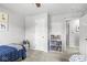 Serene bedroom with doorway, soft carpet, a ceiling fan, a plush toy basket and a bookcase at 3030 E 236Th St, Cicero, IN 46034