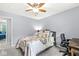Bright bedroom featuring soft light, a comfortable bed, a desk and chair, and a ceiling fan at 3030 E 236Th St, Cicero, IN 46034