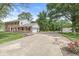 Brick home featuring a long drive leading to a detached garage and basketball hoop at 3030 E 236Th St, Cicero, IN 46034