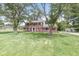 Classic brick two-story home with black shutters, green lawn and mature trees, and detached garage at 3030 E 236Th St, Cicero, IN 46034