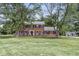Charming two-story brick home featuring a well-maintained lawn and mature trees, offering classic curb appeal at 3030 E 236Th St, Cicero, IN 46034