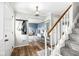 Inviting foyer featuring hardwood floors, staircase, and coat rack, creating a warm entrance at 3030 E 236Th St, Cicero, IN 46034
