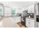 Bright kitchen features white cabinets, modern appliances, and plenty of counter space at 3030 E 236Th St, Cicero, IN 46034