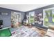 Bright living room with a large window, play kitchen, and soft blue walls at 3030 E 236Th St, Cicero, IN 46034