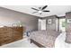 This main bedroom shows a decorative bed, dresser, and large window at 3030 E 236Th St, Cicero, IN 46034