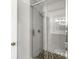 Contemporary shower featuring gray subway tile, glass door, river rock flooring, and sleek gold hardware at 3030 E 236Th St, Cicero, IN 46034