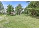 Expansive grassy backyard with mature trees and well-manicured lawn, perfect for outdoor activities and relaxation at 3030 E 236Th St, Cicero, IN 46034
