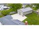 Aerial view showcasing a detached two-car garage with a large concrete pad and a well-kept lawn on a sunny day at 3113 Westenedge Dr, Columbus, IN 47203