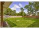 Expansive backyard featuring lush green grass and a wooden privacy fence at 3113 Westenedge Dr, Columbus, IN 47203