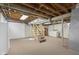 Unfinished basement with exposed ceiling and staircase at 3113 Westenedge Dr, Columbus, IN 47203