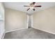 Bright bedroom features neutral walls, ceiling fan, and plush carpet flooring at 3113 Westenedge Dr, Columbus, IN 47203