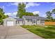 Charming single-story home with a well-maintained lawn, attached garage, and a classic design with black shutters at 3113 Westenedge Dr, Columbus, IN 47203