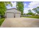Exterior of the detached, oversized two-car garage, next to the spacious driveway and yard at 3113 Westenedge Dr, Columbus, IN 47203