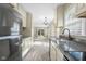 Galley kitchen with stainless steel appliances and gray countertops, opening to living room at 3113 Westenedge Dr, Columbus, IN 47203