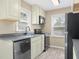 Kitchen showcasing stainless appliances, gray countertop, neutral cabinetry, and natural light at 3113 Westenedge Dr, Columbus, IN 47203