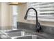 Kitchen sink with a stainless steel faucet and view of the backyard at 3113 Westenedge Dr, Columbus, IN 47203