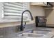 Kitchen detail of sink with stainless faucet, and black cooktop at 3113 Westenedge Dr, Columbus, IN 47203