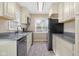 Updated kitchen with stainless appliances, light colored cabinets and gray countertops at 3113 Westenedge Dr, Columbus, IN 47203