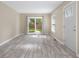 Open living space with wood-look floors, sliding glass doors to the backyard, and a bright, airy feel at 3113 Westenedge Dr, Columbus, IN 47203