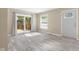 Bright living room with sliding glass door and light gray wood grain flooring at 3113 Westenedge Dr, Columbus, IN 47203
