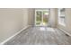 Bright and airy living room showcasing wood-look flooring, sliding doors to the backyard, and neutral walls at 3113 Westenedge Dr, Columbus, IN 47203