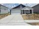 Charming single-story home with blue siding, a white garage door, and a well-manicured lawn at 3266 W Longbranch Dr, Monrovia, IN 46157