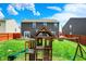Landscaped backyard with lush green grass, playset, and outdoor entertaining space at 3284 Clary Blvd South Dr, Greenwood, IN 46143