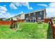 Backyard with a well-maintained lawn, playset, and outdoor seating area at 3284 Clary Blvd South Dr, Greenwood, IN 46143
