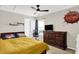 Cozy bedroom with carpeted floors, ceiling fan, and a decorative basketball on the wall at 3284 Clary Blvd South Dr, Greenwood, IN 46143