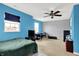 A colorful bedroom featuring bright blue walls, carpeted floors, and large windows at 3284 Clary Blvd South Dr, Greenwood, IN 46143