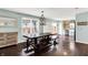 Dining area featuring a long wooden table and benches, stylish lighting, and hardwood floors at 3284 Clary Blvd South Dr, Greenwood, IN 46143