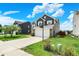 Inviting home with a basketball hoop over the garage, long driveway, and well-maintained lawn at 3284 Clary Blvd South Dr, Greenwood, IN 46143