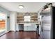 Bright kitchen featuring stone accent wall, modern appliances, and a walkout to the patio at 3284 Clary Blvd South Dr, Greenwood, IN 46143