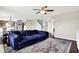 Spacious living room featuring stylish hardwood floors, an inviting blue sectional, and an open-concept design at 3284 Clary Blvd South Dr, Greenwood, IN 46143