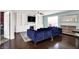 Cozy living room featuring built-in shelving, fireplace, hardwood floors and a plush blue sectional sofa at 3284 Clary Blvd South Dr, Greenwood, IN 46143
