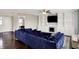 Open living area featuring a fireplace, hardwood floors, and a plush blue sectional sofa at 3284 Clary Blvd South Dr, Greenwood, IN 46143
