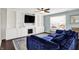 Comfortable living room featuring a built-in fireplace, hardwood floors, and a plush blue sectional sofa at 3284 Clary Blvd South Dr, Greenwood, IN 46143