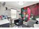 Salon with a chair, mirror, and sink against a colorful floral wall decor at 3284 Clary Blvd South Dr, Greenwood, IN 46143