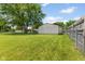Spacious backyard showcasing a well-maintained lawn and detached garage with adjacent fencing at 3427 Donald Ave, Indianapolis, IN 46224