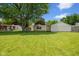 Large backyard featuring well-maintained lawn, mature tree, and a detached garage at 3427 Donald Ave, Indianapolis, IN 46224