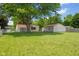 Large backyard featuring well-maintained lawn, mature tree, and a detached garage at 3427 Donald Ave, Indianapolis, IN 46224
