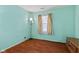 Bright bedroom with wood flooring, window, curtains, and unique standing lamp at 3427 Donald Ave, Indianapolis, IN 46224