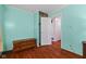 Cozy bedroom with wood flooring, beadboard walls, and storage chest near closet at 3427 Donald Ave, Indianapolis, IN 46224