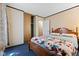 Bedroom with blue carpeting, a wooden bed frame, and a closet at 3427 Donald Ave, Indianapolis, IN 46224