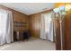 Wood-paneled bedroom with desk, shelves, and windows with light-filtering curtains at 3427 Donald Ave, Indianapolis, IN 46224