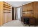 Wood-paneled bedroom features a vintage desk, shelves, and neutral carpet at 3427 Donald Ave, Indianapolis, IN 46224