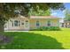 A quaint home featuring a well-kept lawn and neat landscaping around the foundation at 3427 Donald Ave, Indianapolis, IN 46224