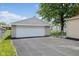 The property features a detached garage with a large driveway and traditional style garage door at 3427 Donald Ave, Indianapolis, IN 46224