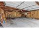 View of garage interior showing exposed framing, a concrete floor, and a rear window at 3427 Donald Ave, Indianapolis, IN 46224